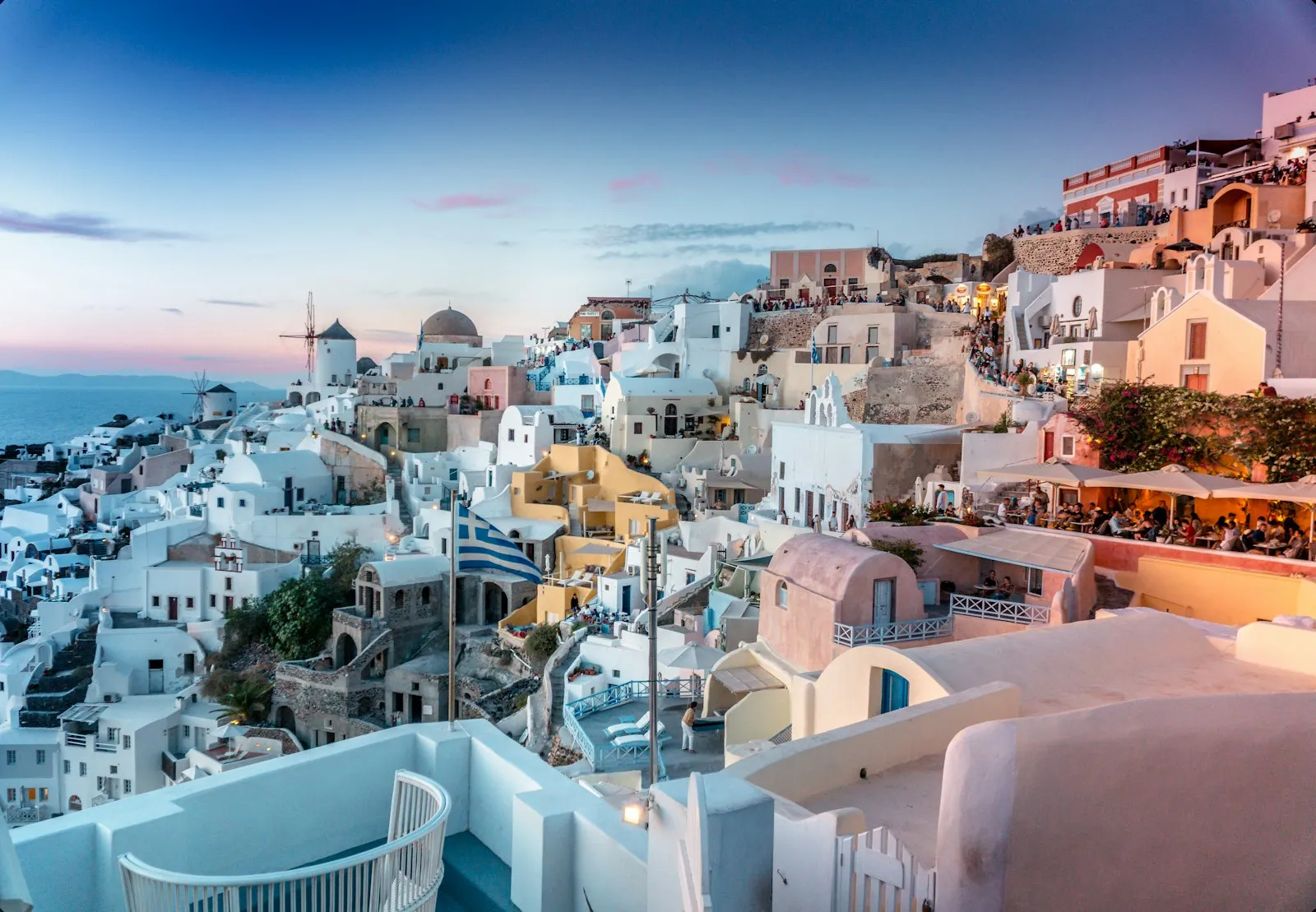 A whitewashed cliffside village at dusk